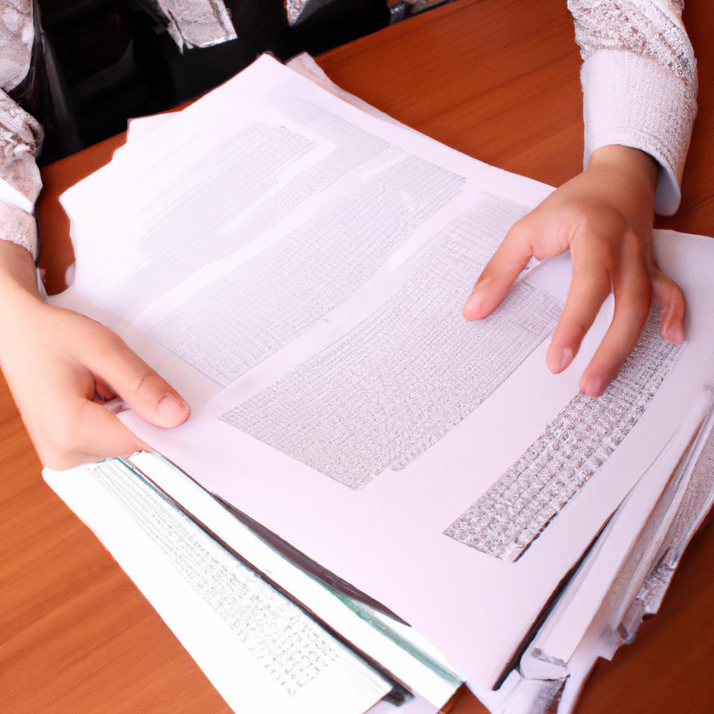Person analyzing documents on desk